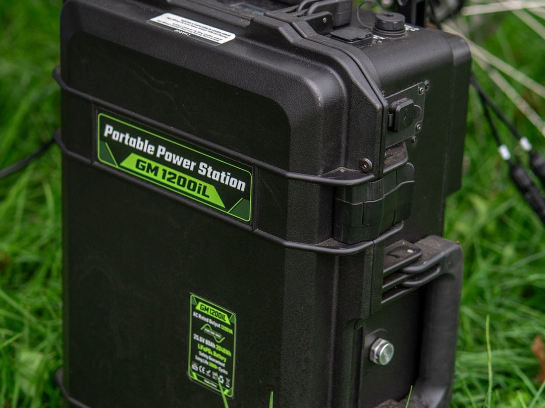 Grid Mate GM1200iL portable power station standing in long grass