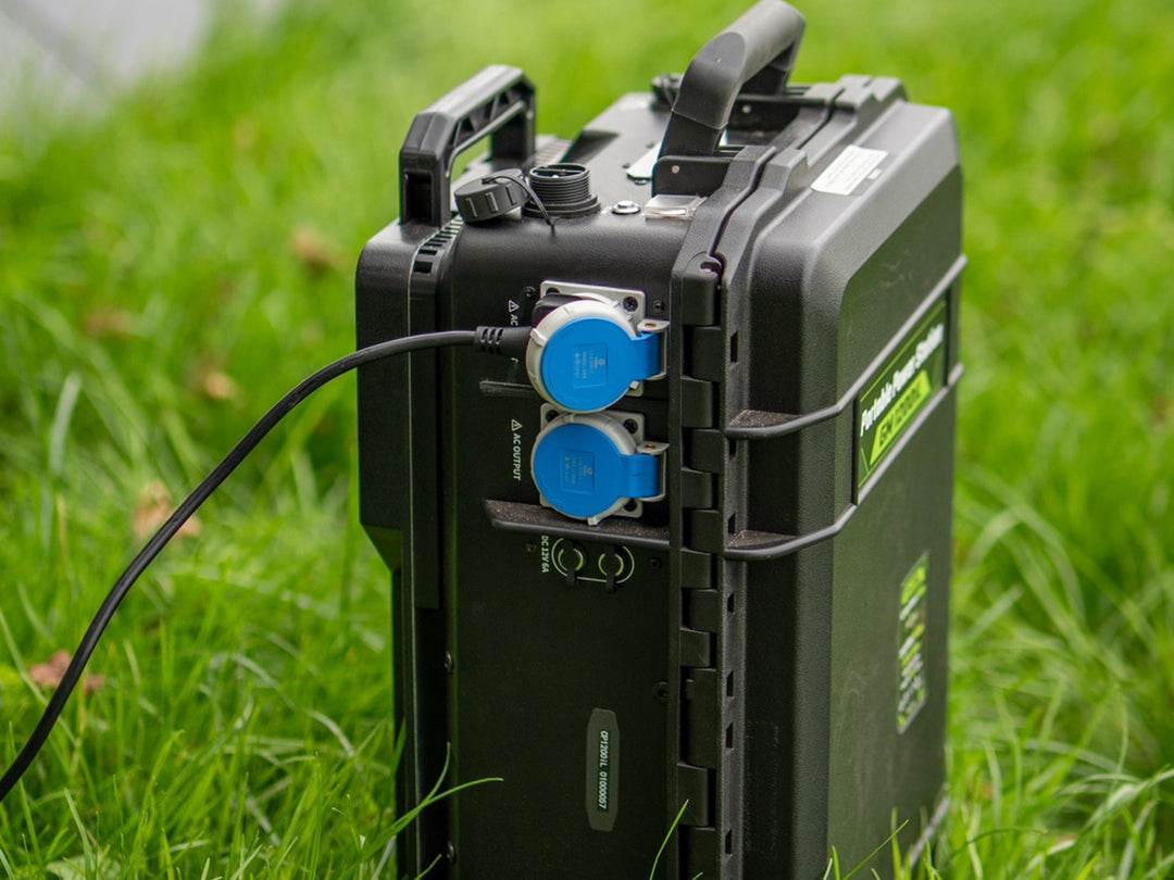 Grid Mate GM1200iL power station with a cable plugged into one of its blue AC outputs