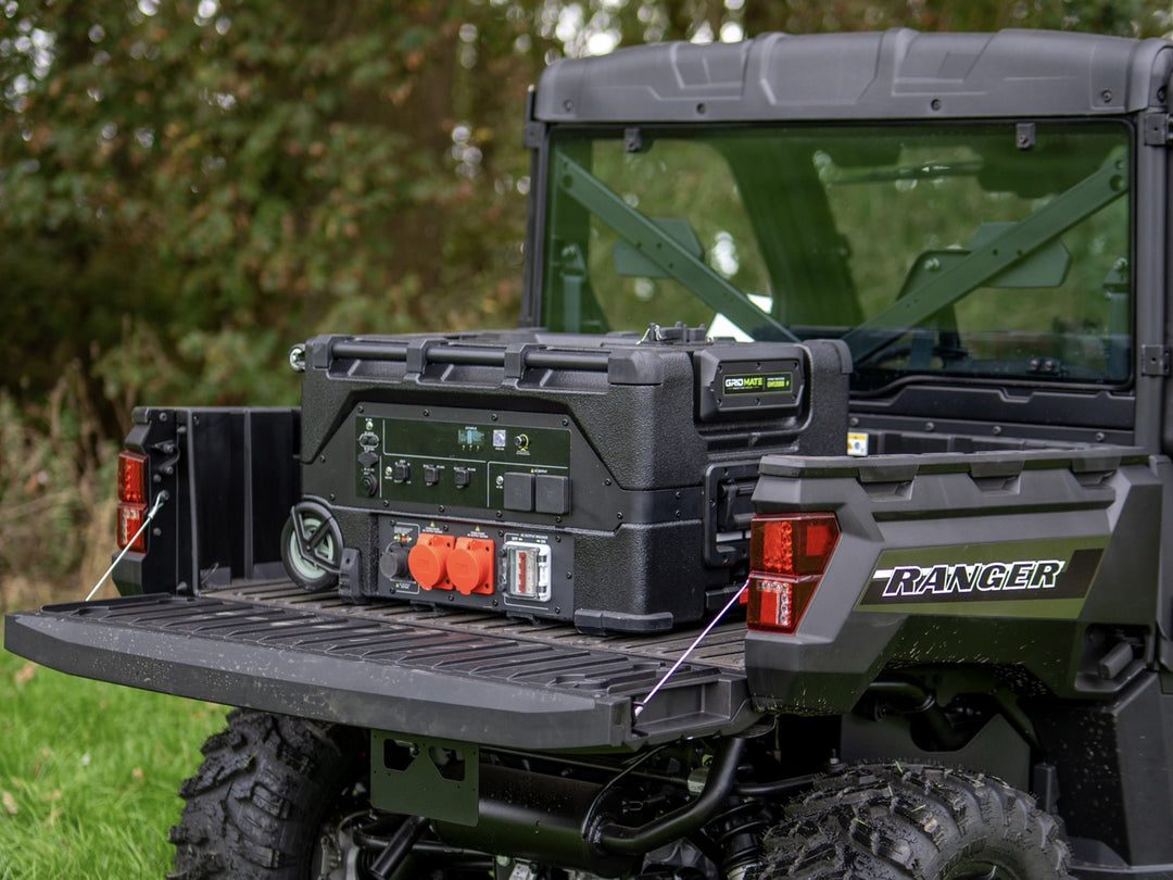 Large Grid Mate power station with its controls and orange sockets on the bed of a utility vehicle